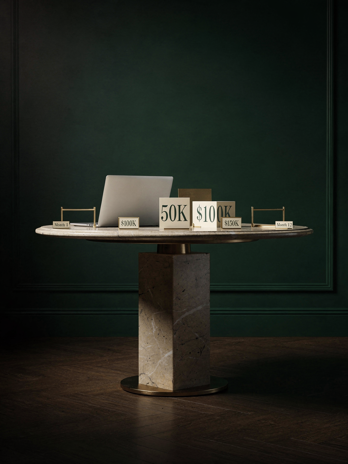 A laptop on a desk against a dark green wall